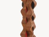 a wooden sculpture of a spiral design on a wooden base