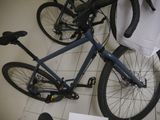 a bicycle that is sitting on the floor next to a bag
