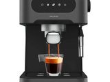 a black coffee machine with a cup of coffee in front of it