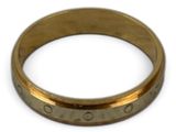 a close up of a gold ring on a white surface