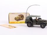 a toy army jeep with a driver in front of a boxed box