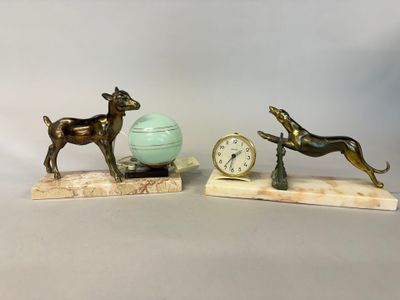 two figurines of a dog and a ball on a table