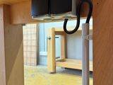a picture of a wooden table with a pair of black cords attached to it
