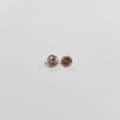 a pair of brown diamonds on a white surface