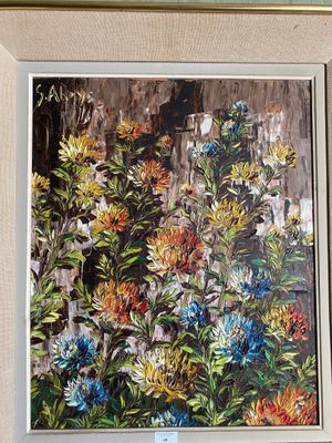 a picture of a painting of flowers hanging on a wall