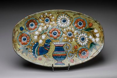 a decorative plate with flowers and a bird on it