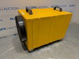 a yellow air conditioner sitting in front of a wall
