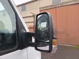 a side view mirror of a truck that is parked in a parking lot