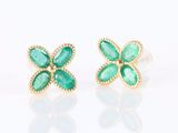 a pair of emerald and gold earrings on a white background