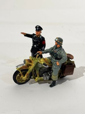 two figurines of a man on a motorcycle and a man on a motorcycle