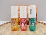 three bottles of perfume sitting on top of a bamboo tray