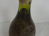 a bottle with a cork on it sitting on a table