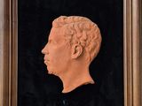 a framed picture of a bust of a man in profile