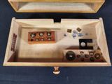 a wooden box that has a bunch of buttons inside of it