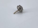 a close up of a small metal object on a white surface