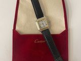 a close up of a watch in a red case on a white surface