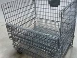 a large metal cage with wheels on the floor