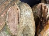 two wooden figurines of a man and a woman