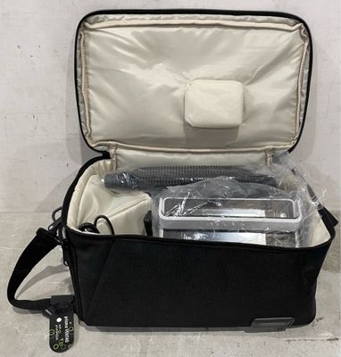 a black bag with some items in it on the floor