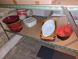many bowls and bowls on a shelf in a room