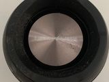 a close up of a black object on a white surface