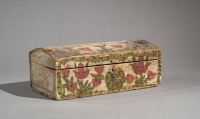 a small wooden box with a floral design on it
