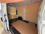 the inside of a van with the door open and a mattress in the back