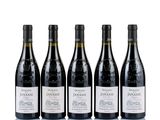 four bottles of wine are lined up on a white surface