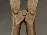 a close up of a pair of pliers on a table