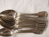 several silver spoons and spoon spoons on a white cloth
