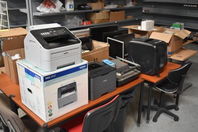 a lot of office supplies on the desk in the room