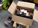 a cardboard box filled with electronic equipment on a table
