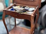 a small wooden table with a mirror on top of it