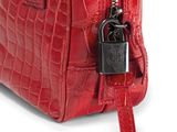 a close up of a red purse with a lock on it