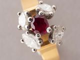 an image of a close up of a ring with a red stone