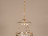 an image of a glass hanging light fixture with a gold chain