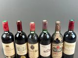 six bottles of wine lined up in a row on a table
