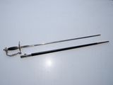 two swords on a table with a chain around them