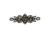 a close up of a black and white diamond broochle