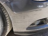 a close up of a car ' s front bumper and tire