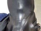 an image of a horse ' s saddle with a bag on the ground