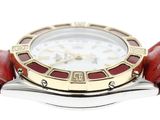 an image of a close up of a wrist watch with a red strap