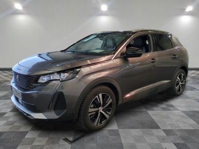 the grey car is parked on a checkered floor in a room