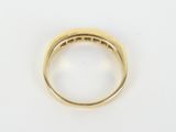 an 18k yellow gold ring with a diamond set in the center
