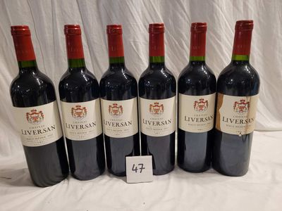 six bottles of wine are lined up on a table