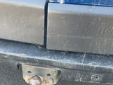 a close up of a car ' s bumper with a rusted bumper