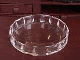 a glass bowl sitting on a table next to a dresser