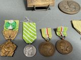 several medals and medals are on a table next to a coin