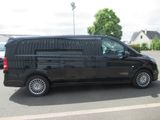 a black van that is parked in a parking lot
