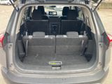 the back of a car with its trunk open and the seats folded down